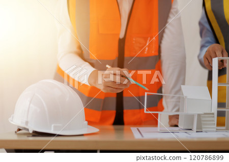 Construction and structure concept of Engineer or architect meeting for project working with partner and engineering tools on model building and blueprint in working site, contract for both companies. 120786899