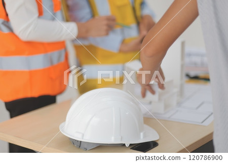 Construction and structure concept of Engineer or architect meeting for project working with partner and engineering tools on model building and blueprint in working site, contract for both companies. 120786900