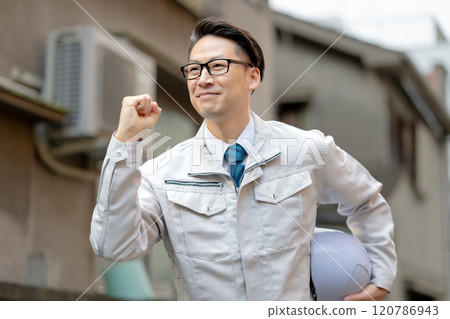 A man in work clothes running 120786943