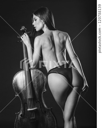 Topless woman standing with cello Topless woman standing with cello 120788139