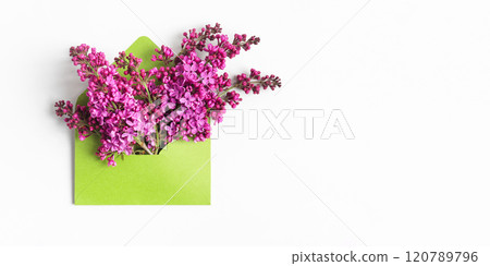 Green envelope with spring flowers purple lilac on gray background. Empty place for inspirational, motivational text or quote. Flat lay. Hello spring Green envelope with spring flowers purple lilac on gray background. Empty place for inspirational, motivational text or quote. Flat lay. Hello spring 120789796