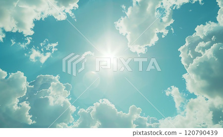 A clear blue sky dotted with fluffy clouds, illuminated by the bright sun 120790439