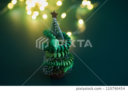 Chinese New Year. A vibrant green snake intertwined on christmas tree 120790454