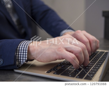 Businessman typing on laptop keyboard in office setting, emphasizing productivity and technology in workplace Businessman typing on laptop keyboard in office setting, emphasizing productivity and technology in workplace 120791088