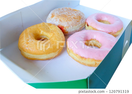 Sweet donuts in a box on a white table. Sweet donuts in a box on a white table. 120791319