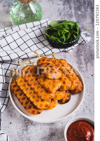 Grilled corn dogs with sausage on a plate and ketchup on the table vertical view Grilled corn dogs with sausage on a plate and ketchup on the table vertical view 120791563