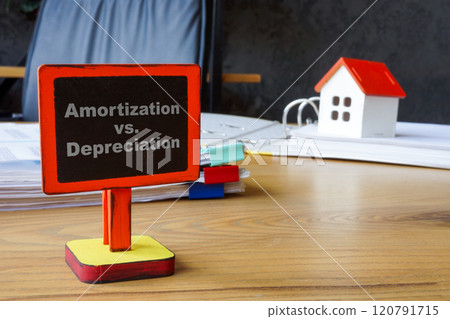 Amortization vs depreciation. Model house symbolizing accounting concept. Amortization vs depreciation. Model house symbolizing accounting concept. 120791715