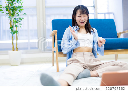 Young woman laughing while watching YouTube videos on a tablet Holiday Relaxing Watching Videos Young woman laughing while watching YouTube videos on a tablet Holiday Relaxing Watching Videos 120792162