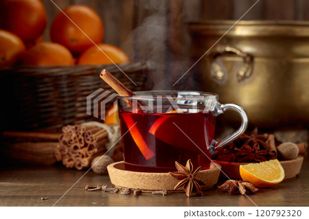 Mulled wine with ingredients on an old wooden table. Mulled wine with ingredients on an old wooden table. 120792320
