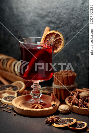 Mulled wine with ingredients and dry orange slices. 120792322
