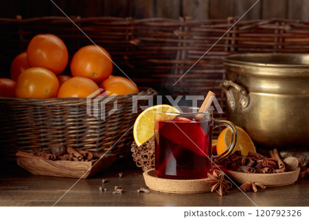 Mulled wine with ingredients on an old wooden table. Mulled wine with ingredients on an old wooden table. 120792326