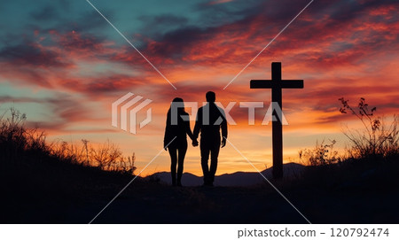 A Romantic Silhouette Set Against a Beautifully Stunning Sunset with a Cross in the Background for Deep Symbolism 120792474