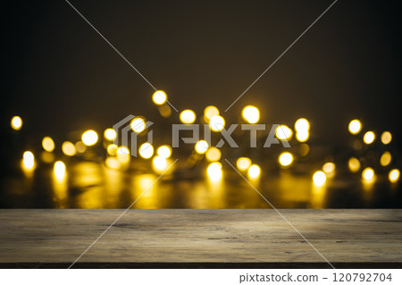 Christmas background table. Lights on backdrop with wooden table 120792704