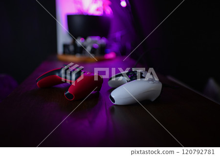 Retro neon game controller. Gamepad for games. Sci-fi Cyber futuristic purple-pink colors joystick. Game Retro neon game controller. Gamepad for games. Sci-fi Cyber futuristic purple-pink colors joystick. Game 120792781