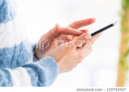 Female hands using phone 120793047