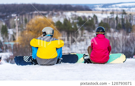 Snowboarders resting on hill Snowboarders resting on hill 120793071