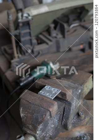 Bracket being held in a vice 120793864