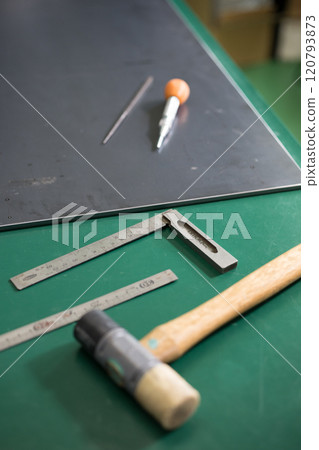 Punching work with an auto punch at the place where holes are to be drilled 120793873