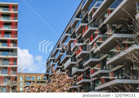 Modern Residential Apartments with Glass Balconies and Red Accents 120794131