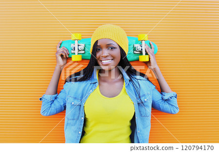 Summer portrait of stylish happy African young woman with skateboard, modern black teenage girl Summer portrait of stylish happy African young woman with skateboard, modern black teenage girl 120794170