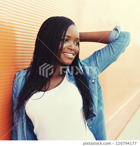 Portrait beautiful happy smiling african woman in city, profile view Portrait beautiful happy smiling african woman in city, profile view 120794177
