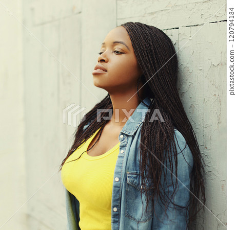 Portrait of beautiful young african woman in city, profile view 120794184