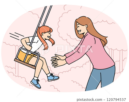 Mom takes daughter on swing in park and enjoys relaxing with child in fresh air. Mom takes daughter on swing in park and enjoys relaxing with child in fresh air. 120794537