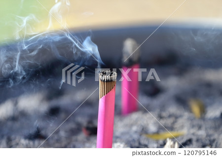 A bundle of incense sticks in a regular incense burner A bundle of incense sticks in a regular incense burner 120795146