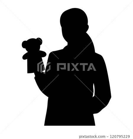 Silhouette of a female nursery teacher with a puppet 120795229