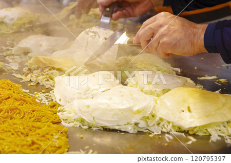 Hiroshima-style okonomiyaki being cooked 120795397