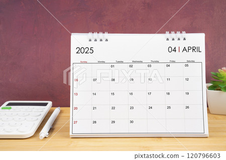 April 2025 white calendar and calculator with pen. April 2025 white calendar and calculator with pen. 120796603