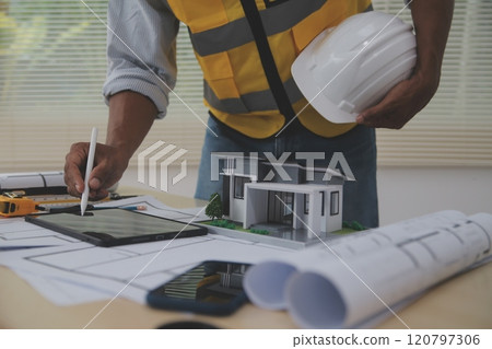 Image of engineer meeting for architectural project. working with partner and engineering tools on workplace vintage tone. 120797306