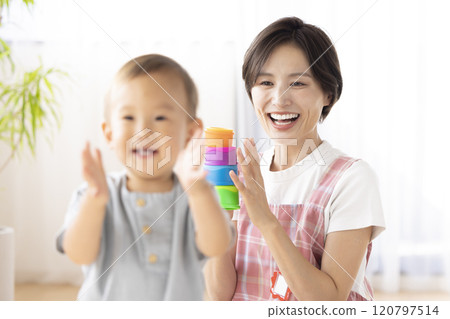 Nursery school children playing with their teachers 120797514