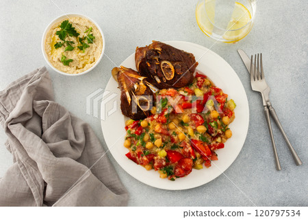 Chickpea stew with stewed vegetables, roasted turkey and hummus 120797534