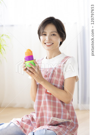 Portrait of a nursery teacher: A woman smiling at the camera 120797653