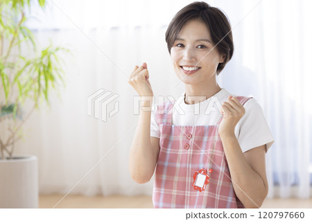 Portrait of a nursery teacher: A woman smiling at the camera 120797660