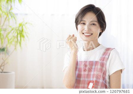 Portrait of a nursery teacher: A woman smiling at the camera 120797681