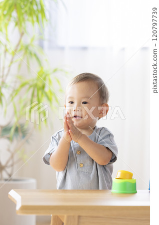 Nursery school children playing with their teachers 120797739