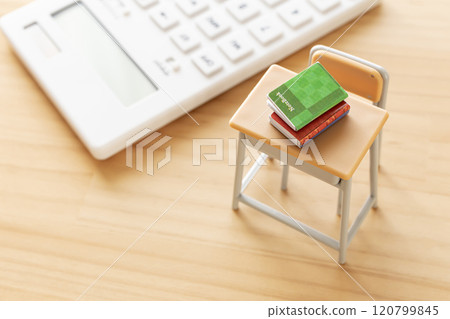Study desk and calculator - image of education and tuition fees Study desk and calculator - image of education and tuition fees 120799845
