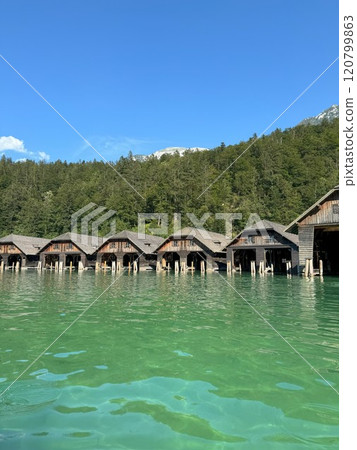 Scenic View of Koenigssee Lakeside Wooden Cabins in Serene Woodland Setting of Bavarian Alps 120799863
