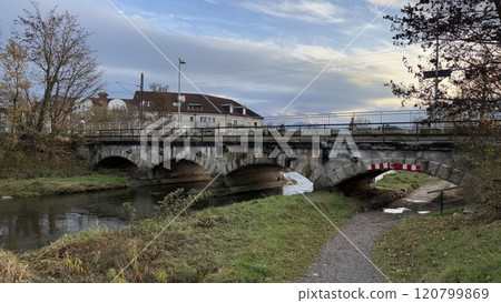 Stone Bridge Over Calm River Mangfall With Idyllic Countryside Setting and Cloudy Sky Stone Bridge Over Calm River Mangfall With Idyllic Countryside Setting and Cloudy Sky 120799869