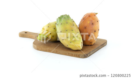 Fresh prickly pears arranged on a wooden cutting board, set against white background Fresh prickly pears arranged on a wooden cutting board, set against white background 120800225