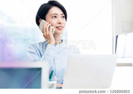 Business woman calling with a smartphone Business woman calling with a smartphone 120800803