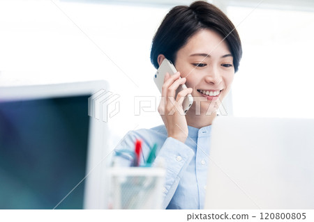 Business woman calling with a smartphone Business woman calling with a smartphone 120800805