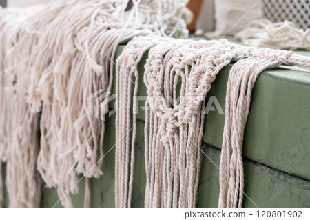 Woman weaves home Handmade decor from cotton thread macrame. Macrame panel creating process. Woman weaves home Handmade decor from cotton thread macrame. Macrame panel creating process. 120801902