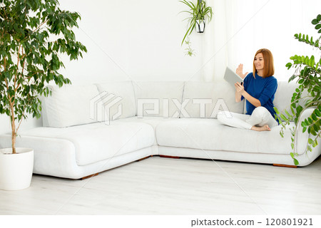 girl talking on the phone. Smiling real woman at home. White interior, copy space girl talking on the phone. Smiling real woman at home. White interior, copy space 120801921