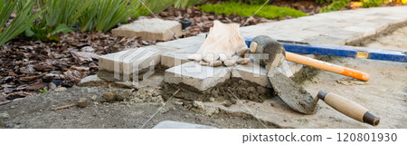 Banner, Laying paving stones on cement mortar. Laying a garden path made of tiles. Self-laying of concrete paving slabs in the courtyard of the house. do it yourself. DIY 120801930