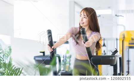 A woman riding a running machine 120802555