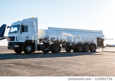 White tank truck aircraft refueler at the airport apron White tank truck aircraft refueler at the airport apron 120802738