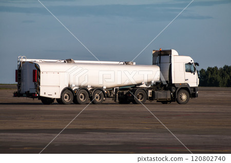 White tank truck aircraft refueler at the airport apron White tank truck aircraft refueler at the airport apron 120802740
